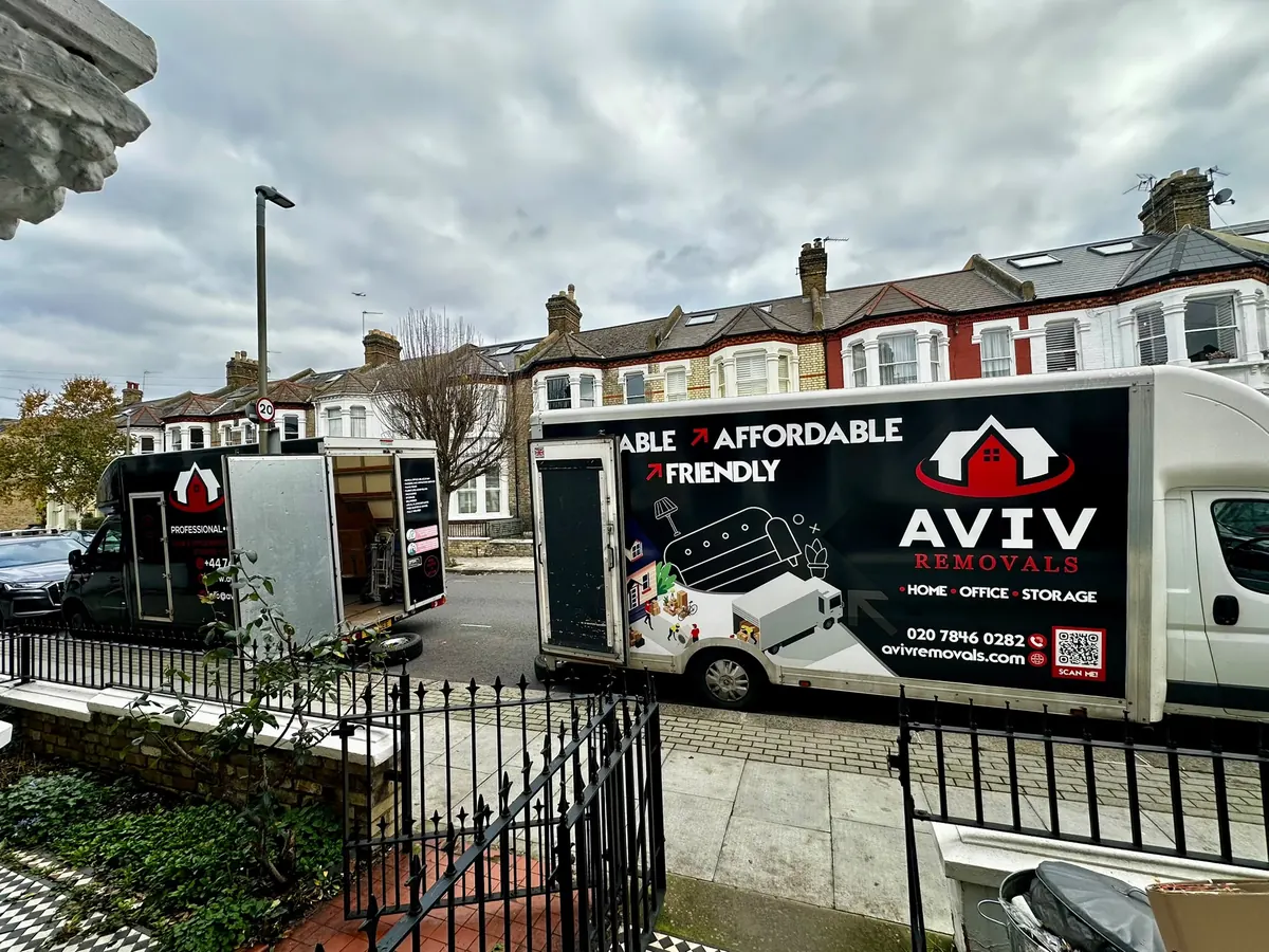 Two Aviv Removals vans outside London terraced houses on moving day